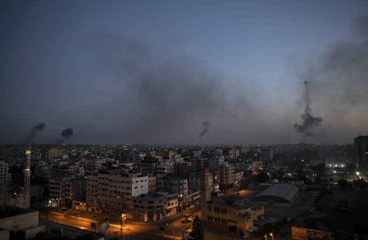 ASSOCIATED PRESS
                                Black smoke rise following Israeli airstrikes on Gaza City, today.