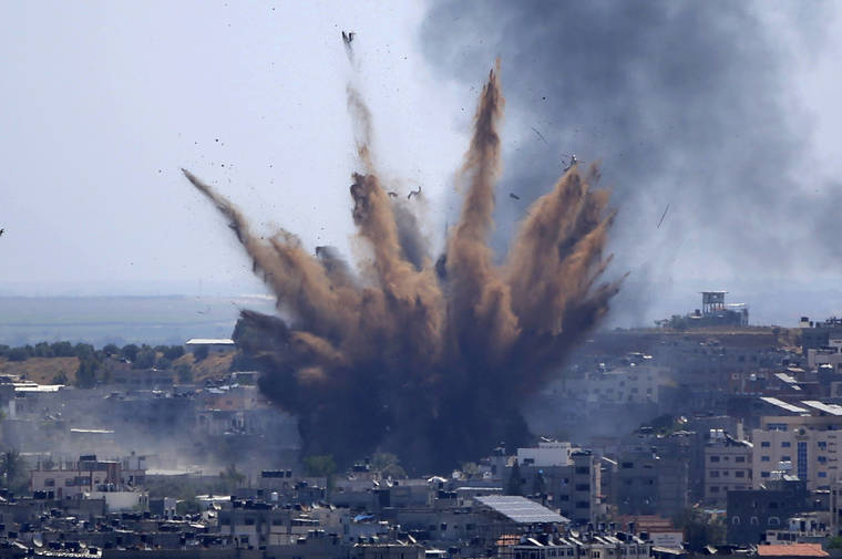 ASSOCIATED PRESS
                                Smoke rose following Israeli airstrikes on a building in Gaza City, today. Weary Palestinians are somberly marking the end of the Muslim holy month of Ramadan, as Hamas and Israel traded more rockets and airstrikes and Jewish-Arab violence raged across Israel.