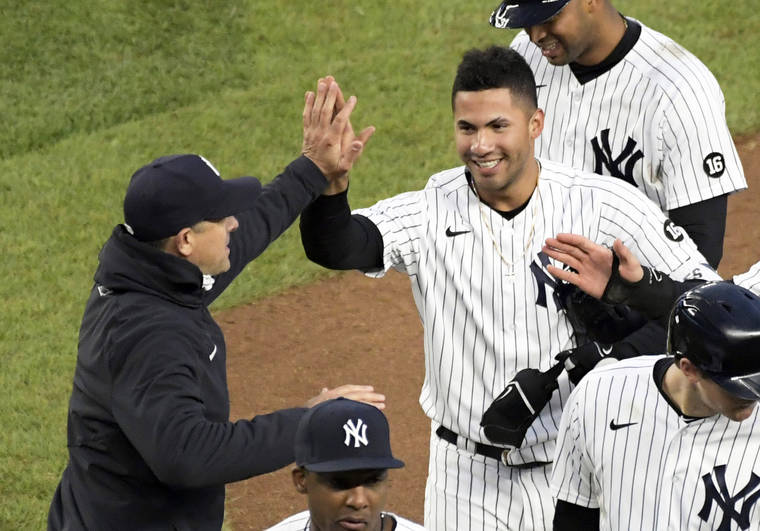 ASSOCIATED PRESS
                                New York Yankees’ Gleyber Torres is congratulated by manager Aaron Boone after Torres drove in the winning run in the 11th inning of the team’s baseball game against the Washington Nationals on Saturday in New York.