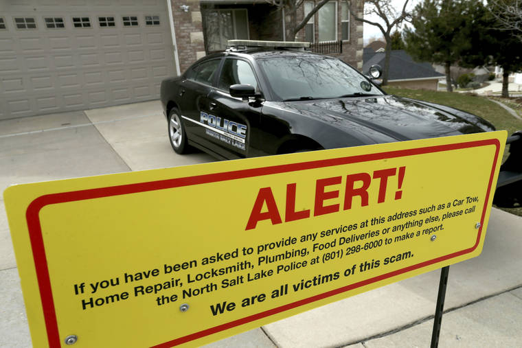COURTESY LAURA SEITZ/THE DESERT NEWA VIA AP / 2019
                                A warning sign and a police officer’s vehicle at Walt Gilmore’s home in North Salt Lake, Utah.
