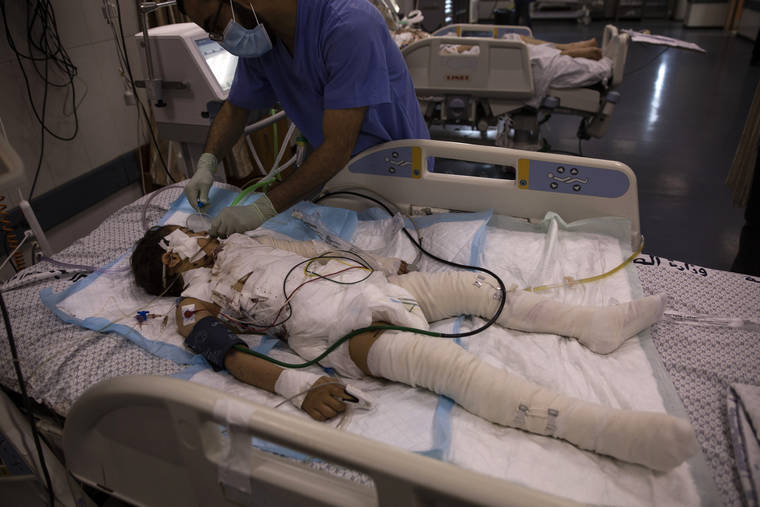 ASSOCIATED PRESS
                                A Palestinian medic gives treatment to a wounded girl in the ICU of the Shifa hospital in Gaza City. She was injured by an Israeli strike that hit her family house.