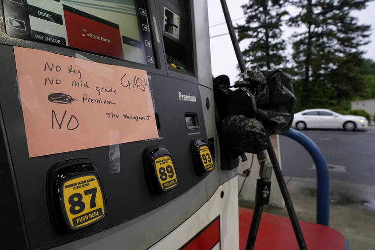 ASSOCIATED PRESS
                                A handwritten sign was posted on a gas pump, Wednesday, showing that the service station is out of all grades of fuel in Charlotte, N.C. Several gas stations in the Southeast reported running out of fuel, primarily because of what analysts say is unwarranted panic-buying among drivers, as the shutdown of a major pipeline by hackers entered its fifth day.