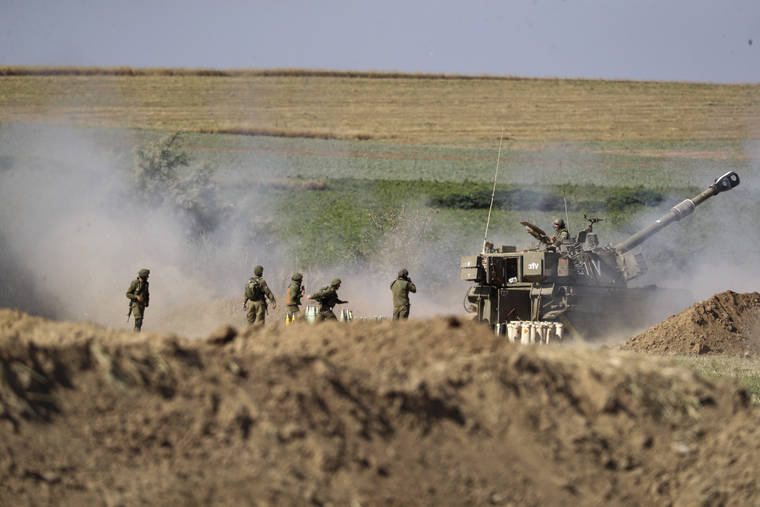 ASSOCIATED PRESS
                                An Israeli artillery unit fires toward targets in Gaza Strip, at the Israeli Gaza border, today.