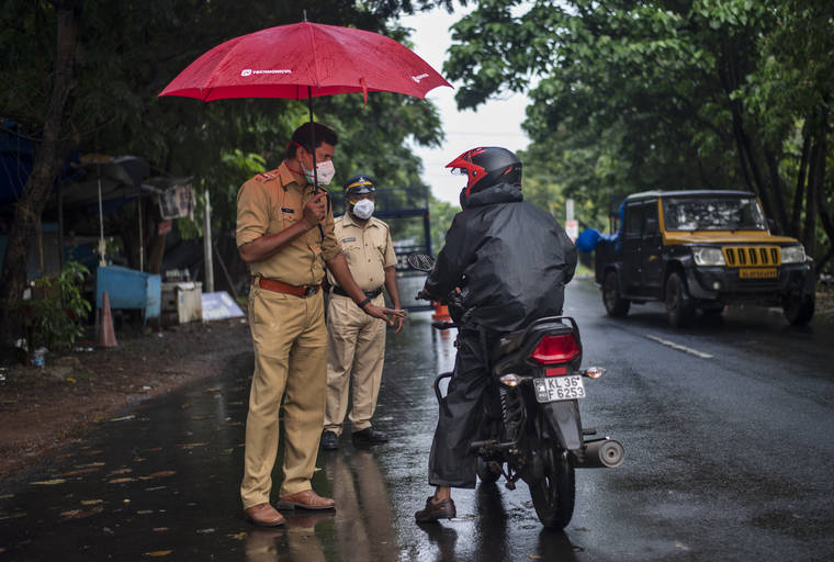 ASSOCIATED PRESS
                                A police officer holds an umbrella to protect himself from the rain as he enforces a lockdown to curb the spread of the coronavirus in Kochi, Kerala state, India, today. A severe cyclone is roaring in the Arabian Sea off southwestern India with winds of up to 140 kilometers per hour (87 miles per hour), already causing heavy rains and flooding that have killed at least four people, officials said.