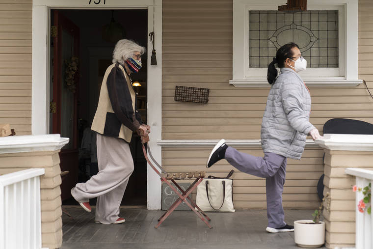 ASSOCIATED PRESS
                                Designer Gere Kavanaugh, left, wears a face mask of her design, as she exercises with Silver Age Home Health licensed vocational nurse Daisy Cabaluna during a weekly outdoors session at her home in the Echo Park neighborhood of Los Angeles, Monday.