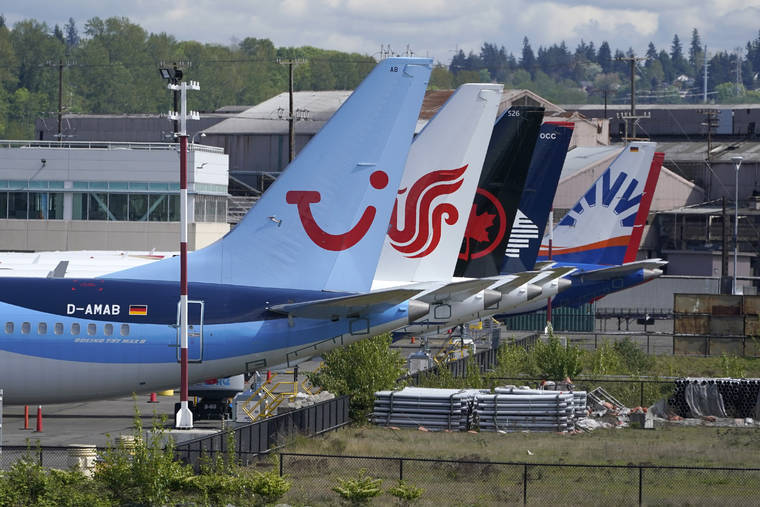 ASSOCIATED PRESS
                                Boeing 737 Max airplanes, including one belonging to TUI Group, left, sit parked at a storage lot on April 26 near Boeing Field in Seattle.