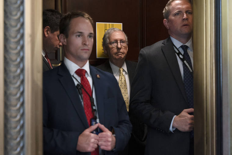 ASSOCIATED PRESS
                                Senate Minority Leader Mitch McConnell of Ky., center, takes an elevator, today, after a meeting with Senate Republicans on Capitol Hill in Washington.