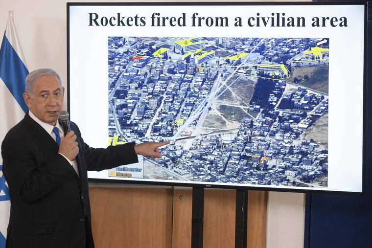 ASSOCIATED PRESS
                                Israeli Prime Minister Benjamin Netanyahu gestures as he shows a slideshow during a briefing to ambassadors to Israel at the Hakirya military base in Tel Aviv, Israel.