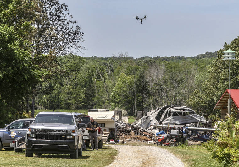 COURTESY GREG EANS/THE MESSENGER-INQUIRER VIA AP
                                Sgt. Scott Rafferty with the Kentucky State Police Critical Incident Response Team flies a drone while mapping the site of a fatal Ohio County shooting at a home, today, in McHenry, Ky.