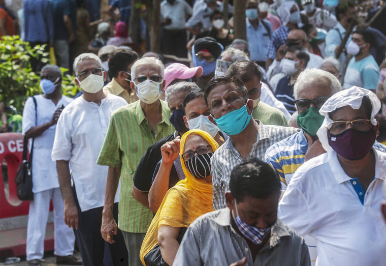 ASSOCIATED PRESS
                                People queue up for coronavirus vaccine in Mumbai, India, on April 26.
