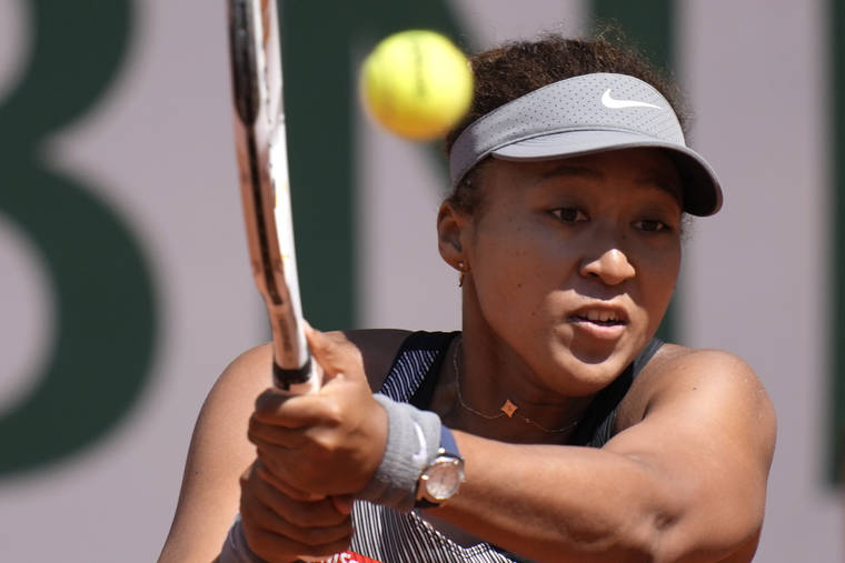 ASSOCIATED PRESS
                                Japan’s Naomi Osaka returns the ball to Romania’s Patricia Maria Tig during their first round match of the French open tennis tournament at the Roland Garros stadium today in
                                Paris.