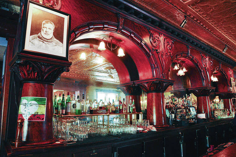 TRIBUNE NEWS SERVICE
                                The mahogany bar at City Park Grill in Petoskey, Mich., boasts a framed portrait of Hemingway.