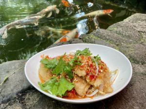 NADINE KAM / SPECIAL TO THE STAR-ADVERTISER
                                Basa fillets at Olay’s Thai-Lao Cuisine can be fried or steamed in your choice of a tart cilantro and lime sauce, or a ginger or red curry sauce. The restaurant offers dining in an outdoor courtyard, with a koi pond and waterfall.