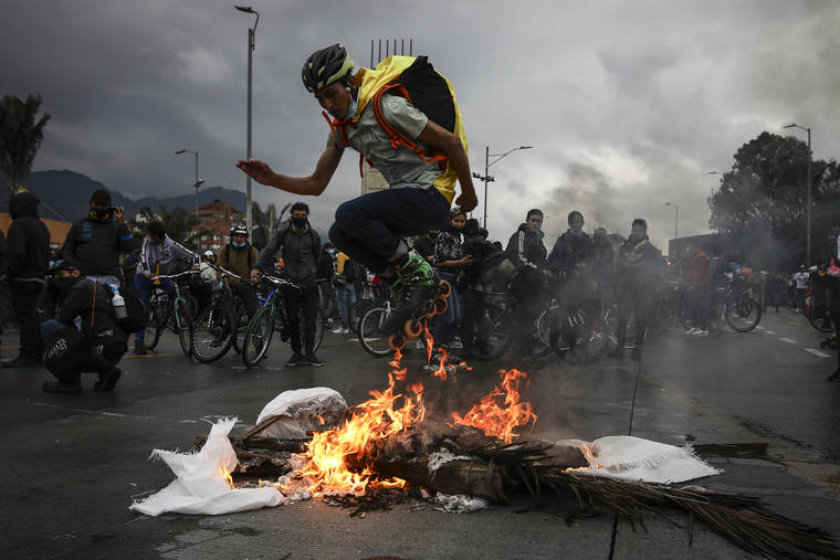 ASSOCIATED PRESS
                                An anti-government demonstrator in skates jumps over a fire during a protest in Bogota, Colombia.
