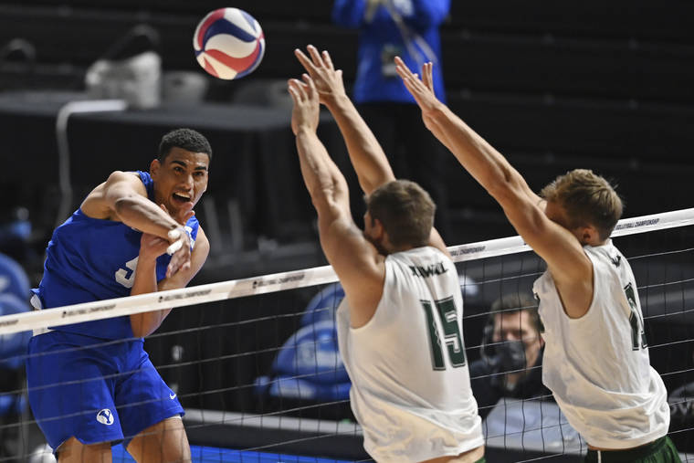 ASSOCIATED PRESS
                                BYU’s Gabi Garcia Fernandez (5) hits the ball as Hawaii’s Patrick Gasman (15) and Jakob Thelle (10) go for a block during the NCAA men’s volleyball championship match today in Columbus, Ohio.