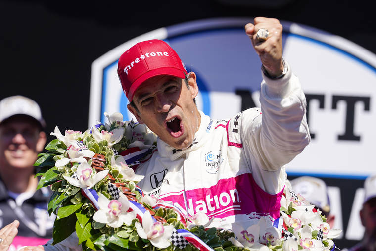 ASSOCIATED PRESS
                                Helio Castroneves of Brazil celebrates after winning the Indianapolis 500 auto race at Indianapolis Motor Speedway in Indianapolis today.