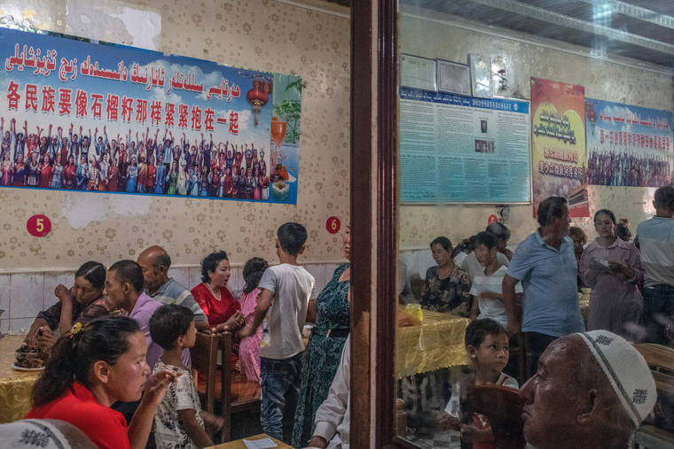 NEW YORK TIMES / 2019
                                “Every ethnic group must tightly bind together like the seeds of a pomegranate,” reads a propaganda poster quoting China’s leader, Xi Jinping, at a restaurant in Yarkand, in the Xinjiang region of China.