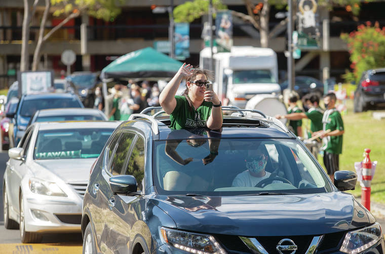 CINDY ELLEN RUSSELL / CRUSSELL@STARADVERTISER.COM
                                A fan waved to the players while approaching the team during Sunday’s drive-by celebration outside the SimpliFi Arena at Stan Sheriff Center.