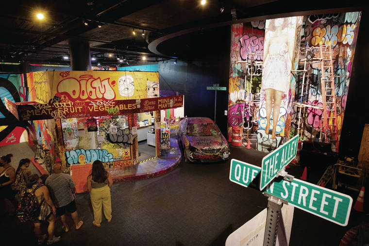 GEORGE F. LEE / GLEE@STARADVERTISER.COM
                                The street-art festival Pow! Wow! Hawaii is celebrating its 10th year with an exhibition at Bishop Museum. A replica of the corner of Queen Street and The Alley features a bodega, a car covered in graffiti and a two-story mural by Kamea Hadar.