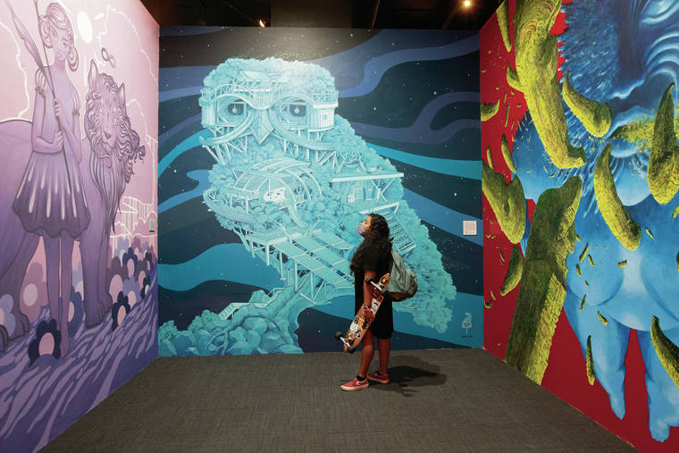 GEORGE F. LEE / GLEE@STARADVERTISER.COM
                                University of Hawaii student Evelyn Belman took in the larger-than-life works of Amy Sol, from left, Wooden Wave and Solomon Robert Nui Enos.