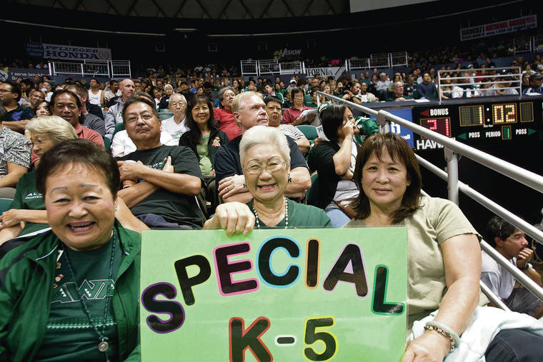 JAMM AQUINO / 2010
                                “Aunties” Lauretta Sewake, left, Lenora Yagi and Florence Kim support the Hawaii volleyball teams and provide lei for players and coaches every home match. They are pictured cheering on the Rainbow Wahine at the Stan Sheriff Center.