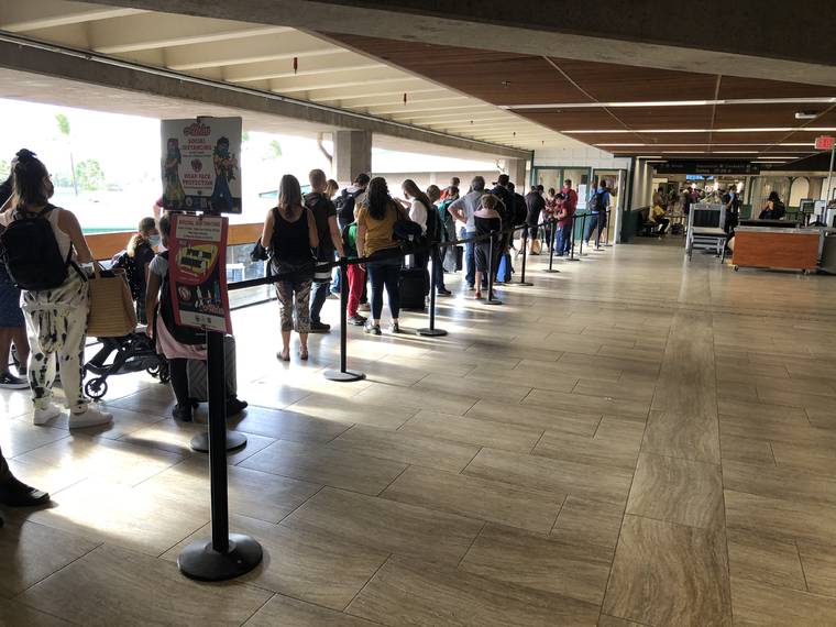 CHRISTIE WILSON / CWILSON@STARADVERTISER.COM
                                Passengers arriving at Kahului Airport, April 2, faced long lines for Safe Travels processing. Maui County is reminding travelers that they must provide documentation of their COVID-19 vaccination to be exempted from the post-arrival testing requirement.