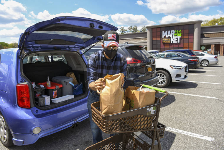 NEW YORK TIMES
                                Joe Glickman loads groceries into his car in Slingerlands, N.Y., outside Albany, on Thursday.