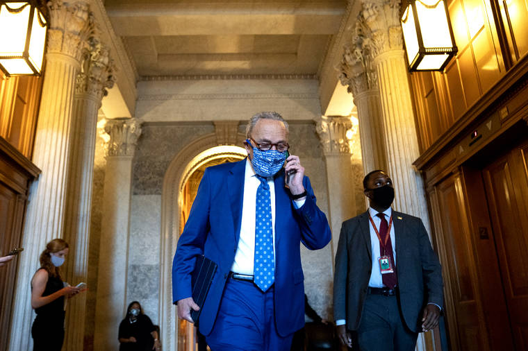 NEW YORK TIMES
                                Senate Majority Leader Chuck Schumer (D-N.Y.) speaks on the phone while departing the Senate Chamber at the Capitol in Washington on Wednesday.