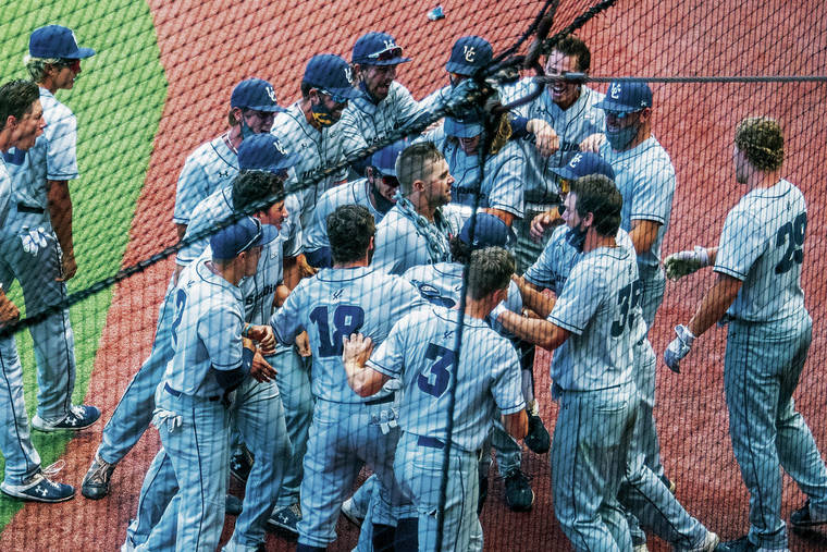CRAIG T. KOJIMA/CKOJIMA@STARADVERTISER.COM
                                UCSD’s Tate Soderstrom, was mobbed by teammates after hitting a home run over the centerfield wall.