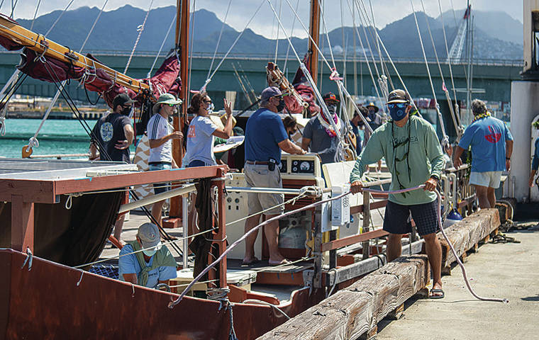 COURTESY POLYNESIAN VOYAGING SOCIETY
                                Crew members of the Hokule‘a prepare to set sail on a three-week training voyage to the doldrums near the equator. The double-hulled voyaging canoe has been in dry dock preparing for next year’s sail around the Pacific.