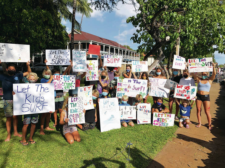 CHRISTIE WILSON / CWILSON@STARADVERTISER.COM
                                Young surfers rallied Tuesday at Lahaina Harbor to urge leaders to allow surfing competitions, which have been banned because of COVID-19 concerns.