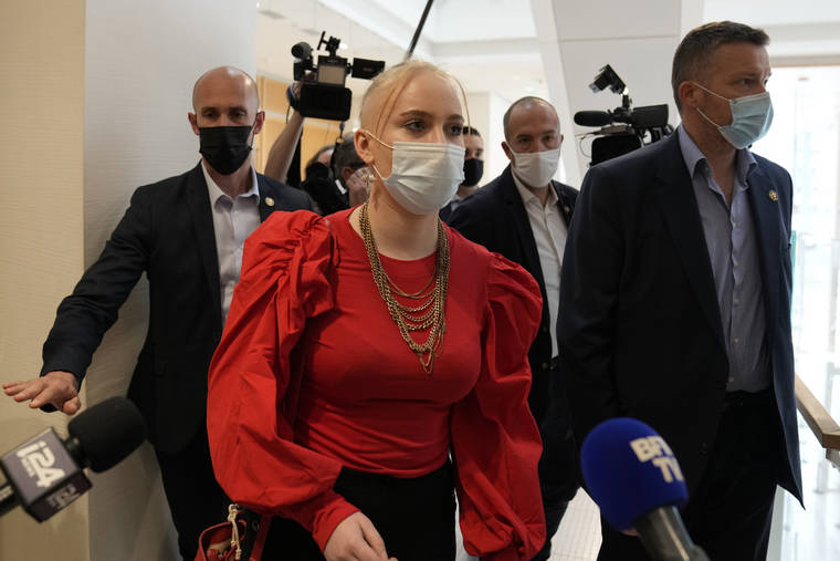 ASSOCIATED PRESS
                                The teenager identifying herself online as Mila left the courtroom, today, in Paris. Thirteen people went on trial toay in Paris accused of cyberbullying or death threats against the teenage girl who posted comments online critical of Islam.