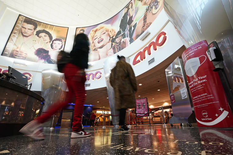 ASSOCIATED PRESS / MARCH 15
                                Movie patrons arrive to see a film at the AMC 16 theater in Burbank, Calif.