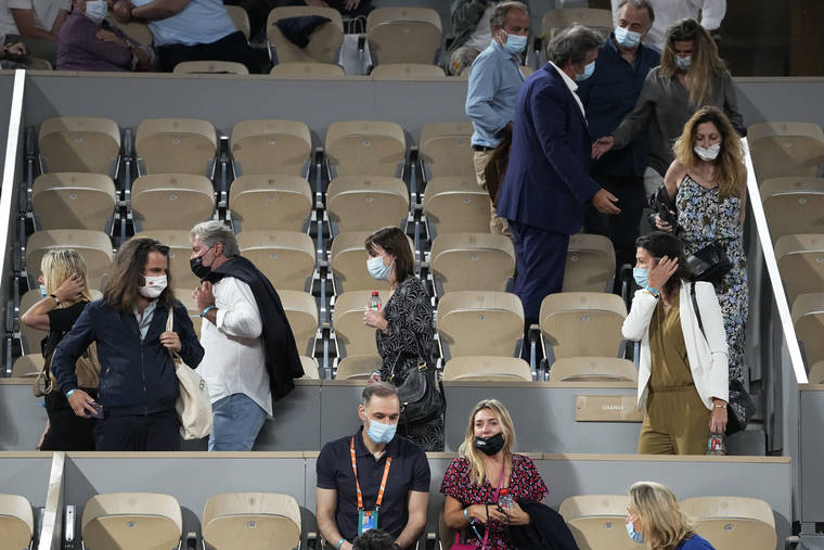 ASSOCIATED PRESS
                                Spectators leave to respect the 11PM curfew due to the COVID-19 pandemic while Italy’s Matteo Berrettini plays Serbia’s Novak Djokovic in a quarterfinal match of the French Open tennis tournament at the Roland Garros stadium today in Paris.