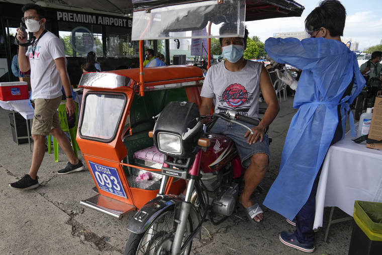 ASSOCIATED PRESS
                                A pedicab driver was inoculated with China’s Sinovac COVID-19 Vaccine in Manila on Tuesday. The Philippine president threatened to order the arrest of Filipinos who refuse the COVID-19 vaccination and told them to leave the country for hard-hit countries like India and the United States if they would not cooperate with massive efforts to end the pandemic.