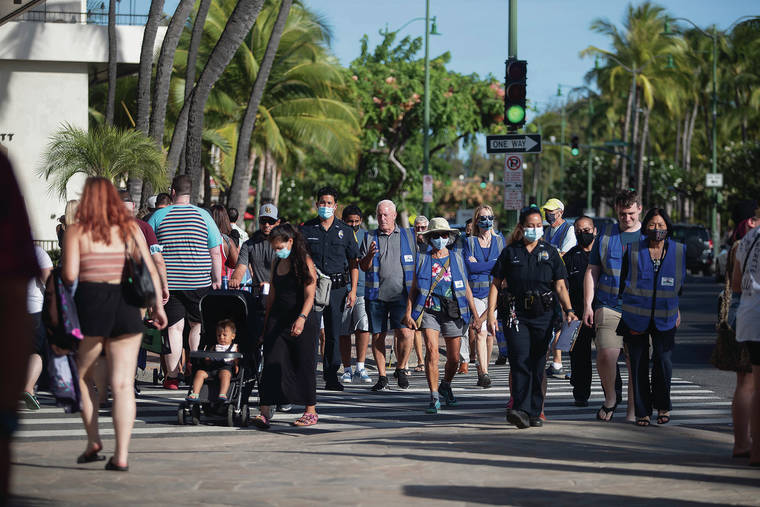 CINDY ELLEN RUSSELL / CRUSSELL@STARADVERTISER.COM
                                Waikiki is the first police district to resume community policing since the start of the pandemic. This is part of a multi-pronged approach to address crime in the state’s top tourist district. The citizen patrol members patrolled along a crowded Kalakaua Avenue on Thursday.
