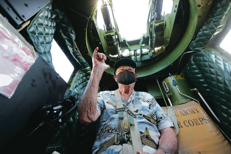 JAMM AQUINO / 2020
                                Former Army Air Force B-25 pilot Col. Jack DeTour flashes a shaka while sitting inside the gunner’s turret of the B-25 Mitchell “Old Glory” prior to a flight in Honolulu.