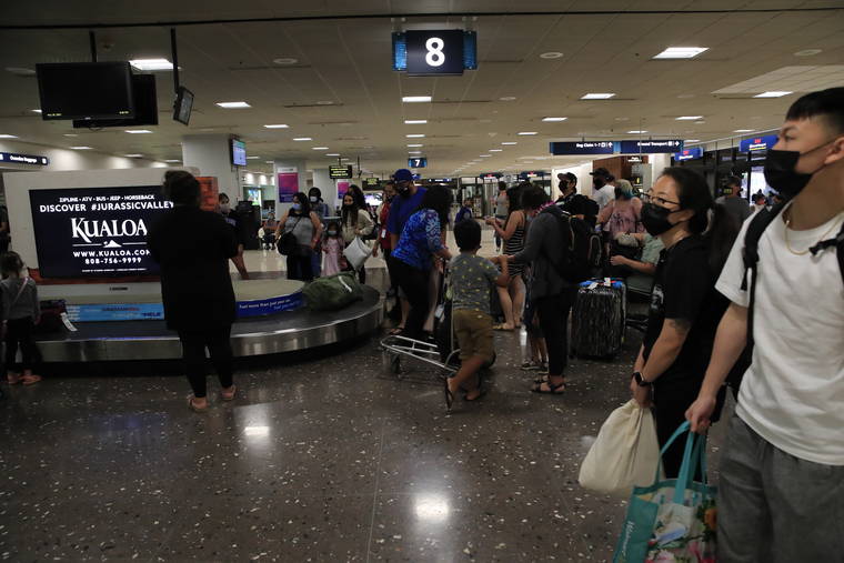 JAMM AQUINO / JAQUINO@STARADVERTISER.COM
                                Passengers waited for their bags in the Hawaiian Airlines baggage claim area, June 15, at Daniel K. Inouye International Airport in Honolulu. July 8  two weeks from now  should represent a major milestone in the fight against COVID-19 in Hawaii when all counties are expected to ease limits on travel and indoor and outdoor gatherings once the islands are expected to see a statewide average of a 60% full vaccination rate.