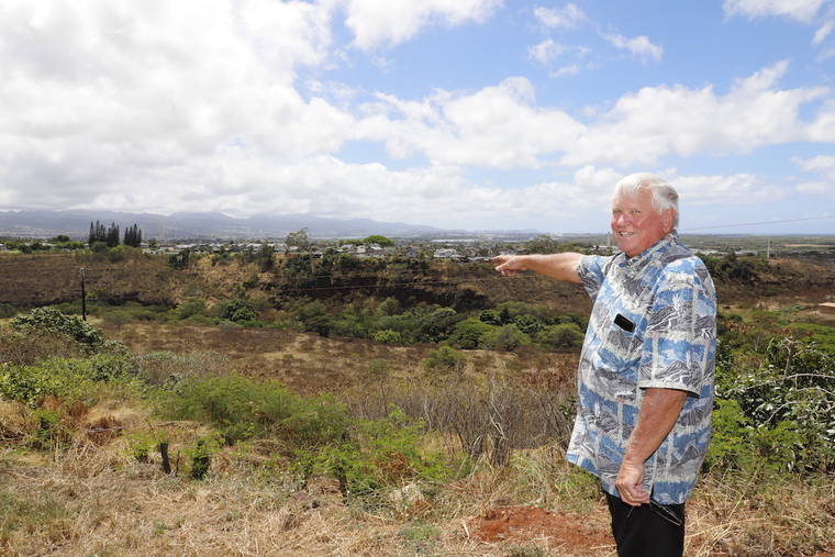 COURTESY SAVIO SOLAR POWER SOLUTIONS
                                Peter Savio points at a lot in Waikele where he plans to build a solar farm that would be sold as units, condominium-style, to buyers.