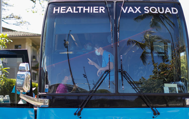 JAMM AQUINO / MAY 22
                                Students, faculty, and their family members are led aboard Hawaii Pacific Health’s vaccination bus for COVID-19 vaccination on May 22 at Punahou School in Makiki.