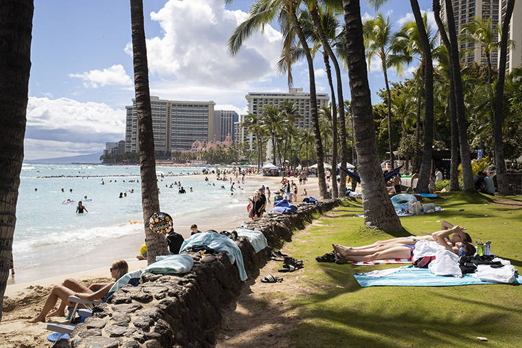 CINDY ELLEN RUSSELL / JULY 8
                                Beachgoers enjoy the sun and surf in Waikiki.