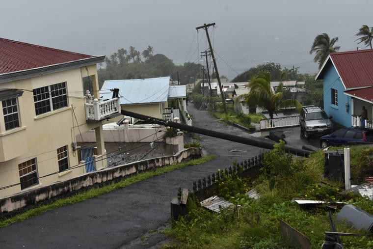 ASSOCIATED PRESS
                                An electrical pole felled by Hurricane Elsa leans on the edge of a residential balcony, in Cedars, St. Vincent, Friday, July 2. Elsa strengthened into the first hurricane of the Atlantic season on Friday as it blew off roofs and snapped trees in the eastern Caribbean, where officials closed schools, businesses and airports.