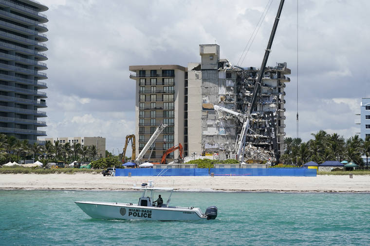 ASSOCIATED PRESS
                                A Miami-Dade County Police boat patrols in front of the Champlain Towers South condo building, where search and rescue efforts continue more than a week after the building partially collapsed in Surfside, Fla.