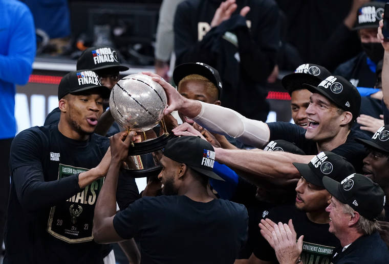 ASSOCIATED PRESS
                                The Milwaukee Bucks hoisted the trophy after defeating the Atlanta Hawks in Game 6 of the Eastern Conference finals of the NBA basketball playoffs, advancing to the NBA Finals.