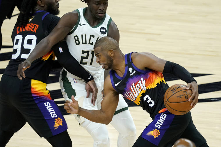 ASSOCIATED PRESS
                                Phoenix Suns guard Chris Paul drives pst Milwaukee Bucks guard Jrue Holiday during the second half of Game 1 of basketball’s NBA Finals, Tuesday, in Phoenix.
