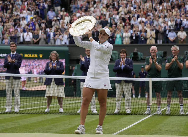 PETE NICHOLS/POOL VIA AP
                                Australia’s Ashleigh Barty poses with the trophy for the media after winning the women’s singles final, defeating the Czech Republic’s Karolina Pliskova on day twelve of the Wimbledon Tennis Championships in London.