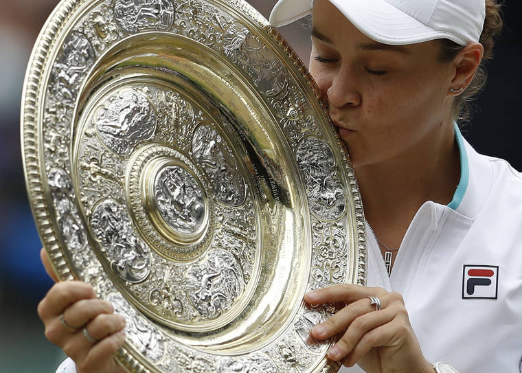 PETE NICHOLS/POOL VIA AP
                                Australia’s Ashleigh Barty poses with the winners trophy for the media after winning the women’s singles final defeating the Czech Republic’s Karolina Pliskova on day twelve of the Wimbledon Tennis Championships in London.