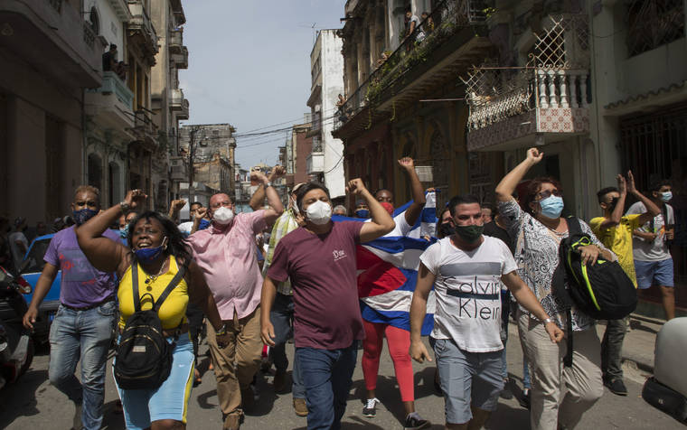 ASSOCIATED PRESS
                                Government supporters shout slogans as anti-government protesters march in Havana, Cuba, today. Hundreds of demonstrators went out to the streets in several cities in Cuba to protest against ongoing food shortages and high prices of foodstuffs.