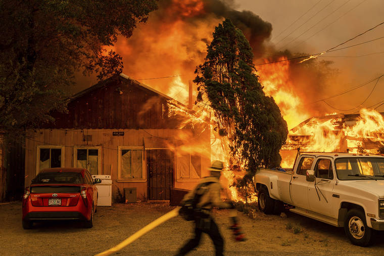 ASSOCIATED PRESS
                                Fire consumed a home as the Sugar Fire, part of the Beckwourth Complex Fire, tore through Doyle, Calif., on Saturday. Pushed by heavy winds, the fire came out of the hills and destroyed multiple residences in central Doyle.