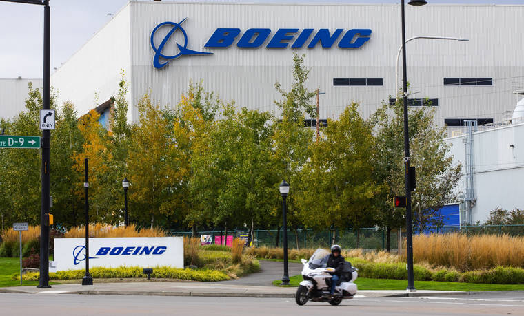 ELLEN M. BANNER/THE SEATTLE TIMES VIA AP / 2020
                                A motorcyclist cruises past the Renton, Wash., Boeing plant where 737’s are built. Boeing is temporarily lowering its delivery target for the 787 Dreamliner after discovering additional work that will need to be performed on the aircraft. The company said Tuesday, July 13, that the 787 production rate will temporarily be lower than five per month and will gradually return to that rate.